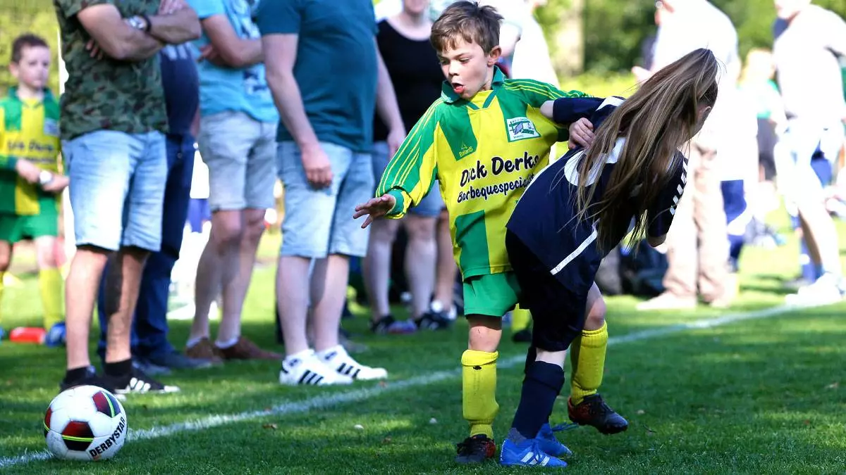 Easter Open Football, where two opposing young players compete for the ball.