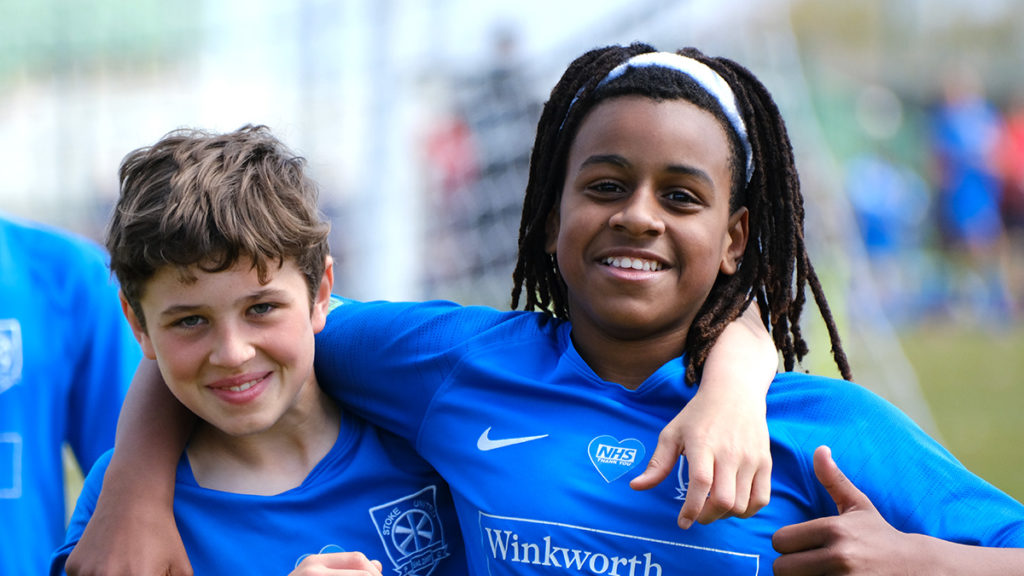 Two boy players pose and smile