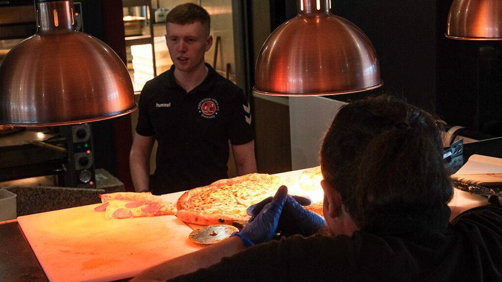 Pizza at the kitchen pass ready to be taken to the Poolfoot Farm restaurant