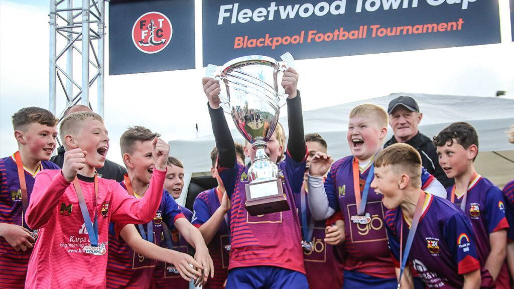 A children's team lift the Fleetwood Town Cup at the Sports Tours Blackpool Football Tournament