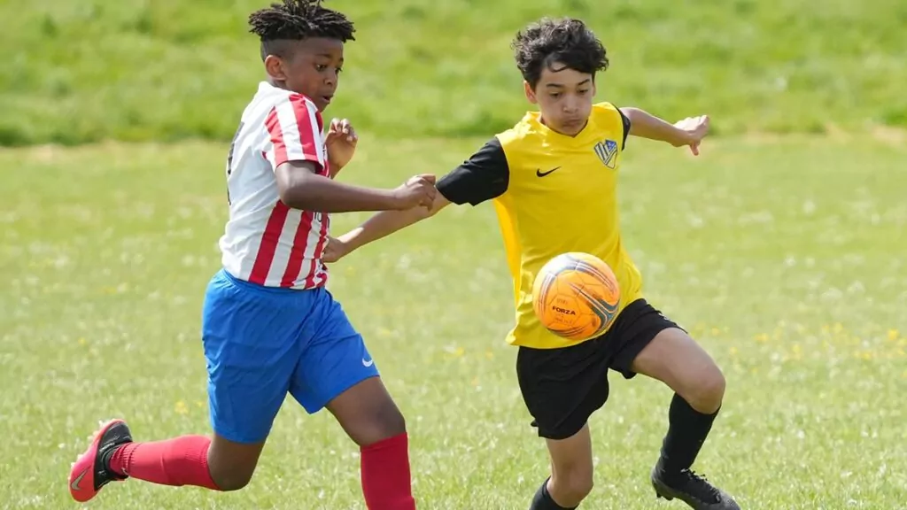 Two players compete for a bouncing football