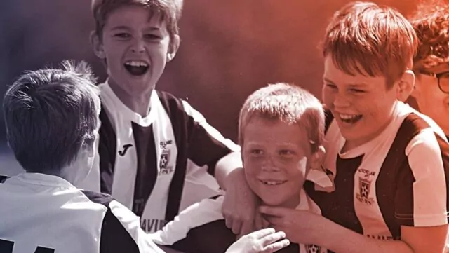 4 boys in striped jerseys celebrate