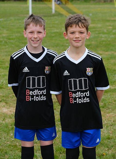 Two boy football players pose