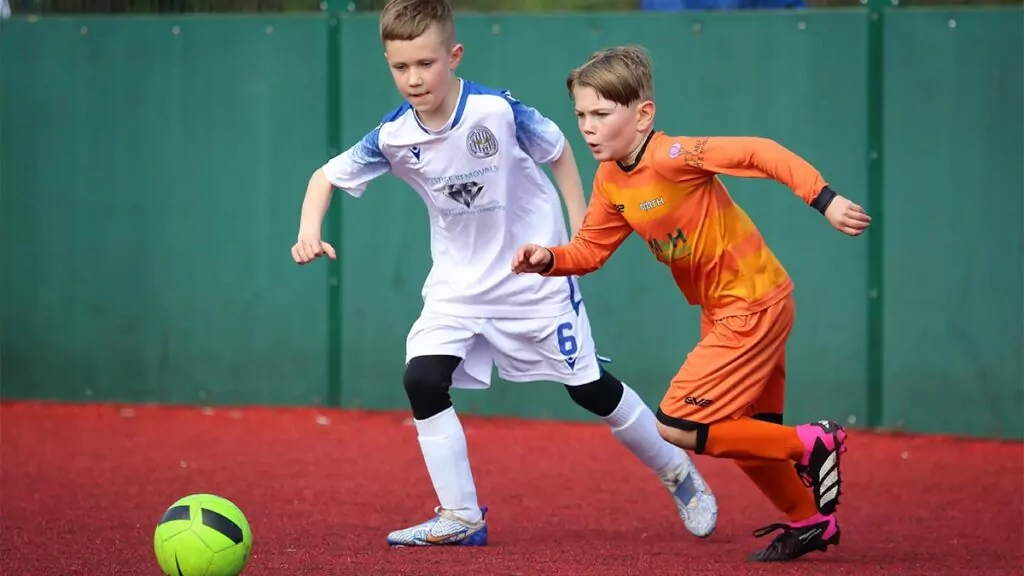 Two players battle it out for the football