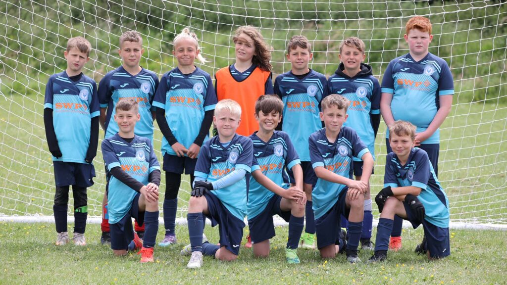 Young football team posing for a photo together