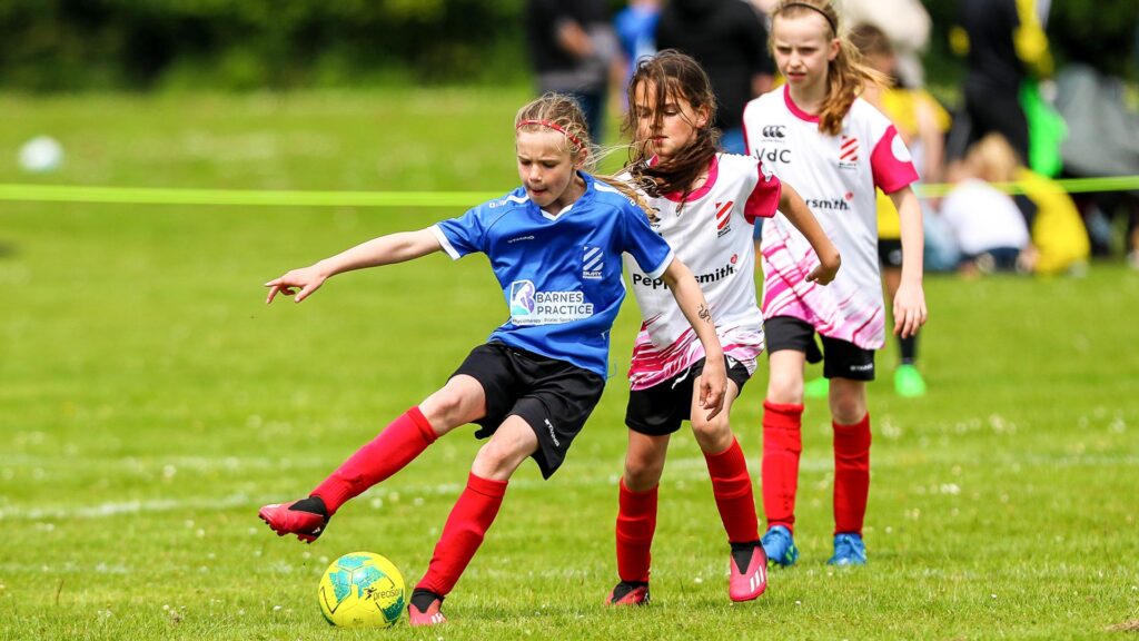 Young girl footballers playing in a UK tournament