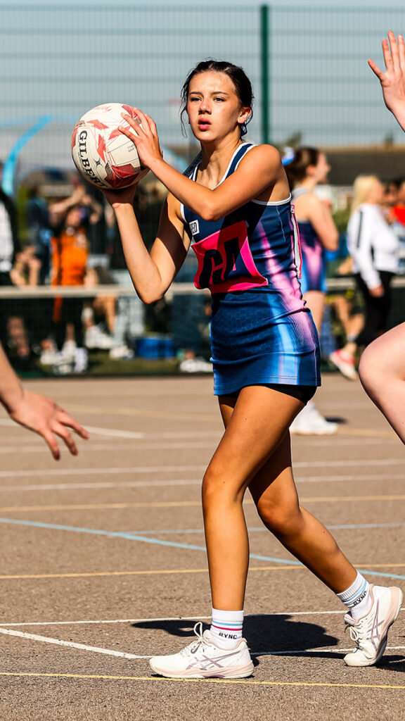 Young netball player prepares to pass