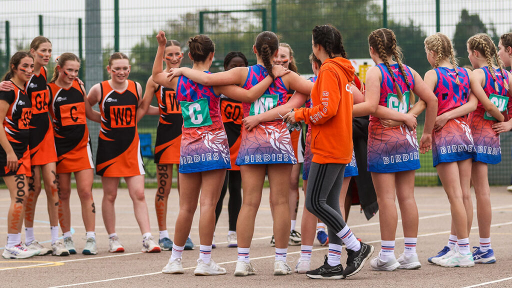 Two netball teams coming together after a match