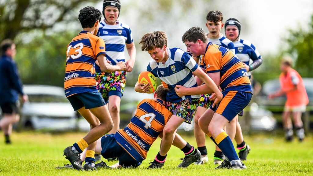 A youth rugby player getting tackled
