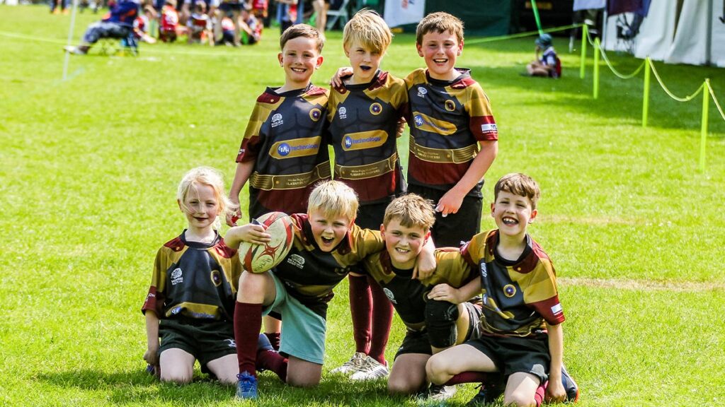 A young rugby team pose for a team photo