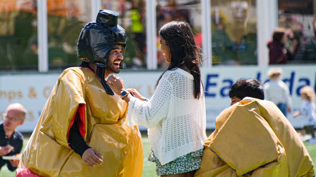 Family members playing in sumo outfits at Heidelberg Materials fun day