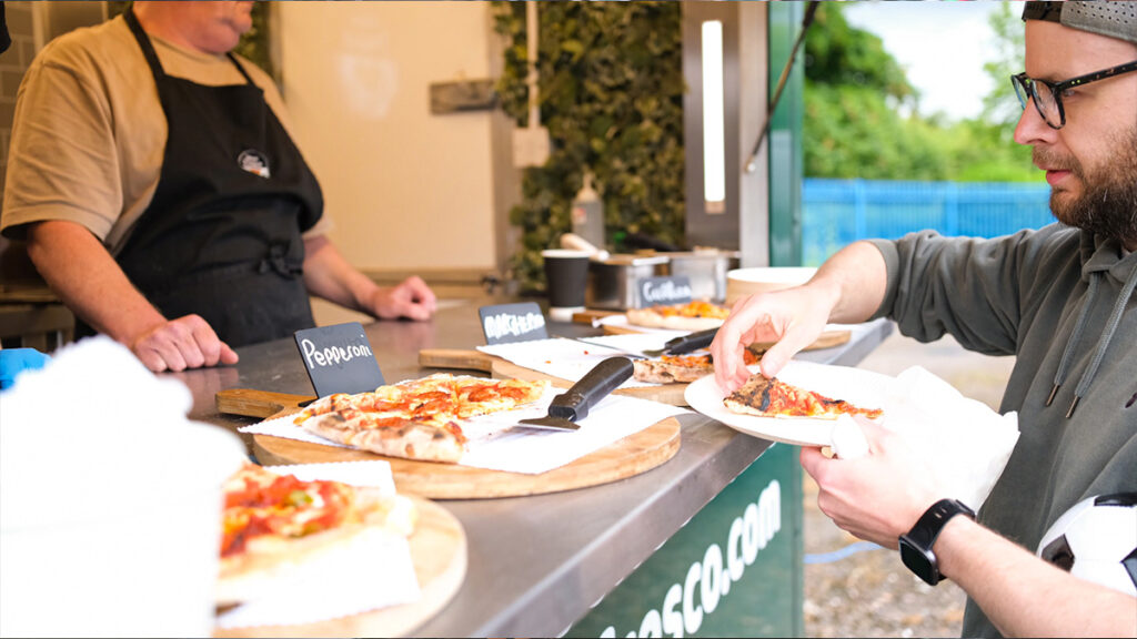Serving pizza at Heidelberg Materials fun day