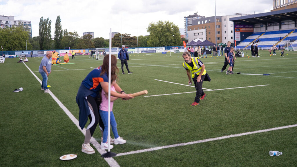 Sports Tours staff members playing rounders with some family members of Heidelberg Materials