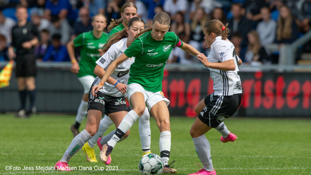Two young girls football teams fight it out for victory at the Dana Cup football tournament