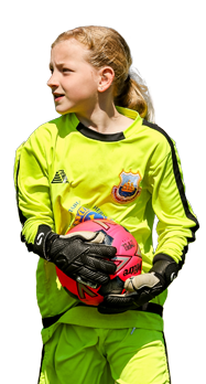 Young girl football goalie holding the ball
