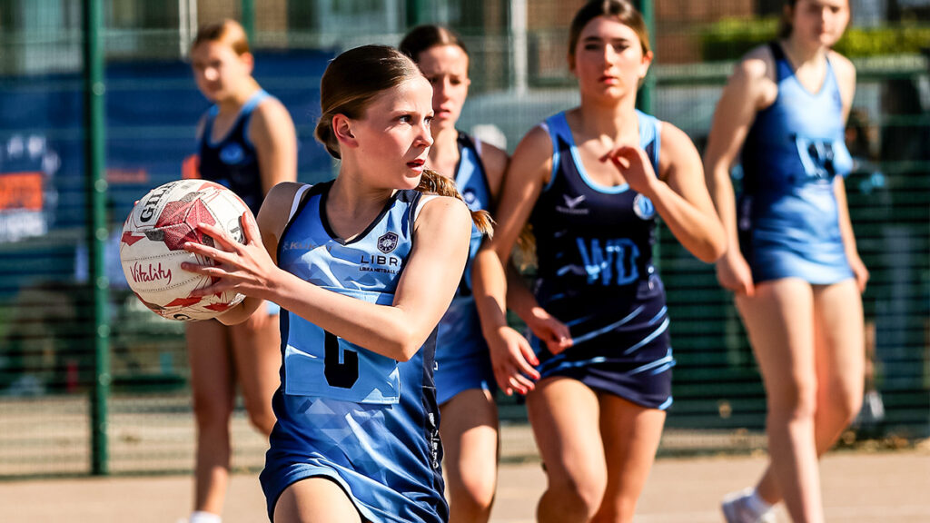 Young netball player looking up field