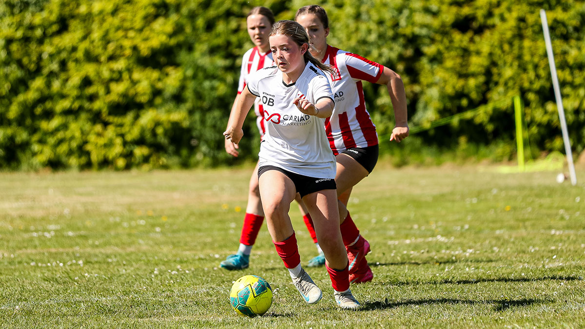 Young girls football teams competing at a tournament