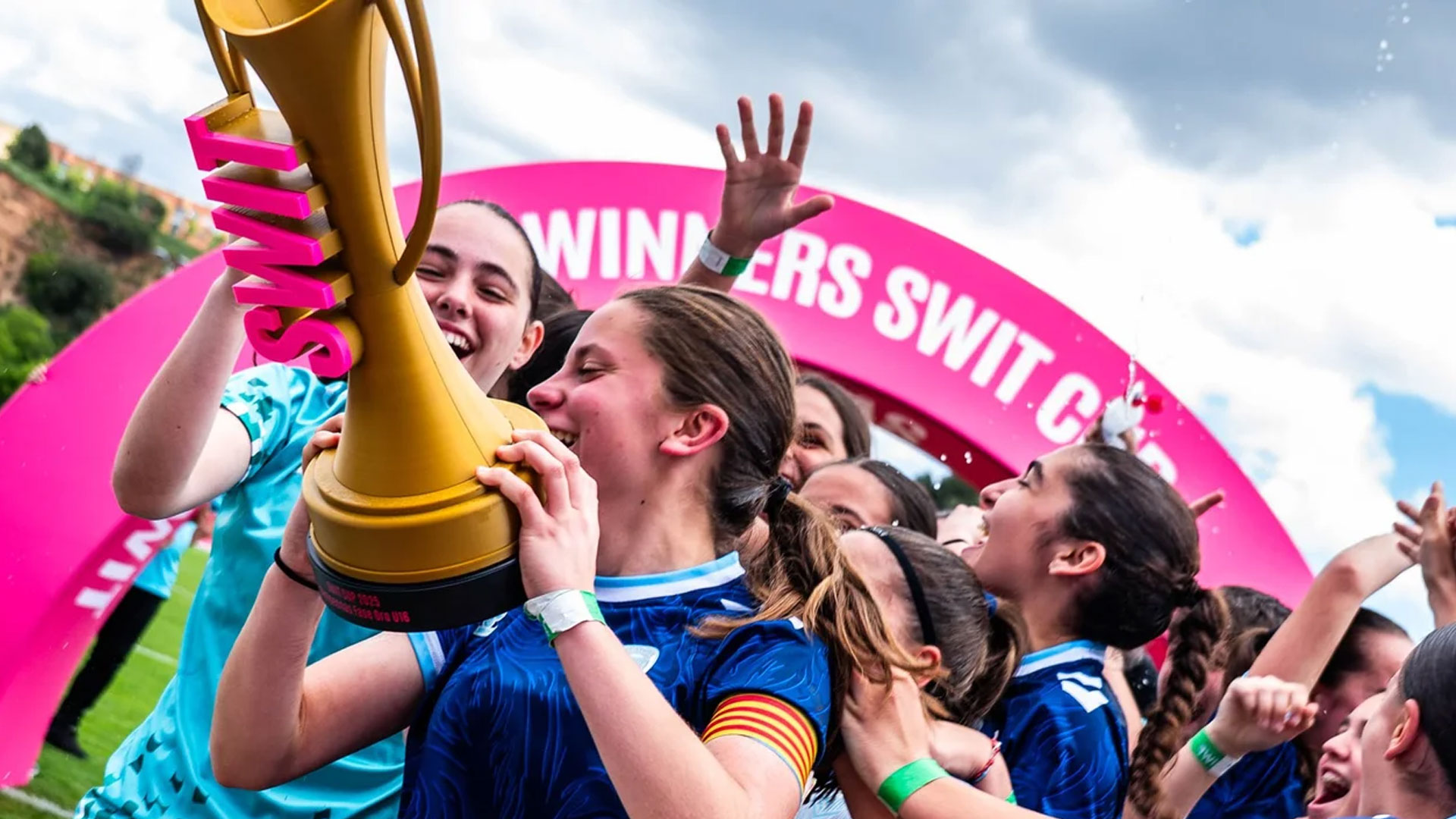A young girls football team celebrating at SWIT cup