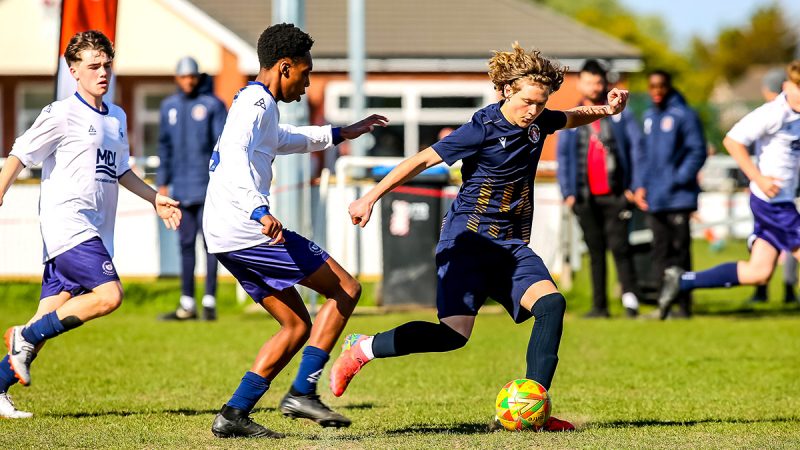 Two young footballers competing at a tournament