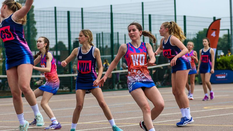 Young netball players playing a match