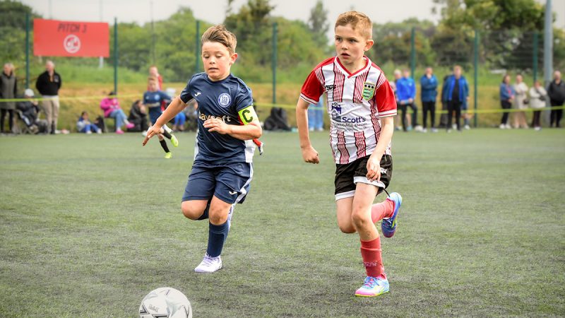 Two young footballers competing at a tournament