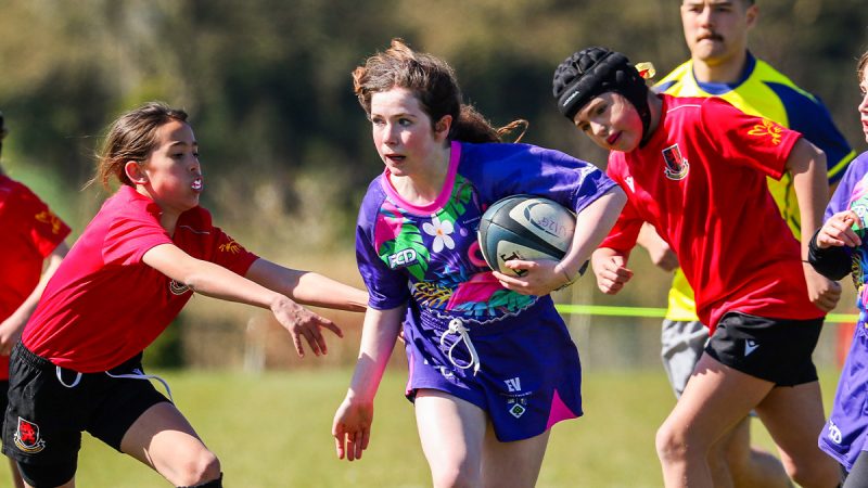 Two young girls rugby teams battle it out at a tournament