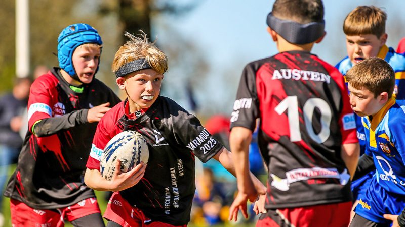 A young rugby player pushing up field