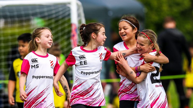 Girl footballer players celebrating after a goal
