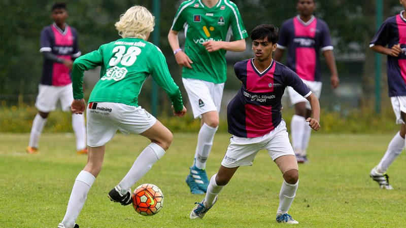 Two young footballers battling it out at the Rey Cup