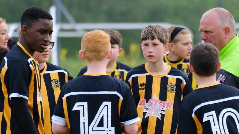Young football players in discussion about tactics before play
